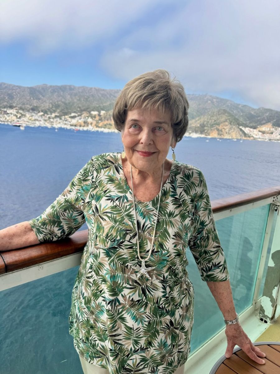 Dorothy posed with her jewelry and palm shirt along what appears to be the rail 